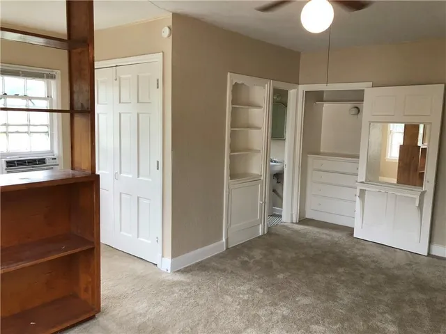 a view of an empty room with a kitchen
