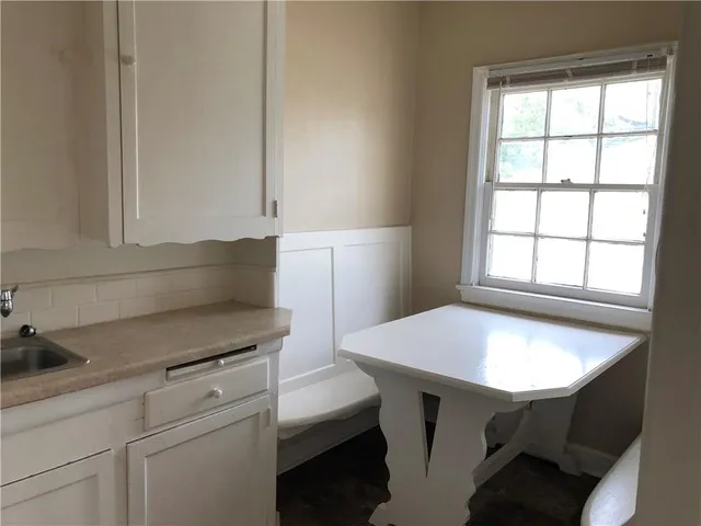 a kitchen with a sink cabinets and a window