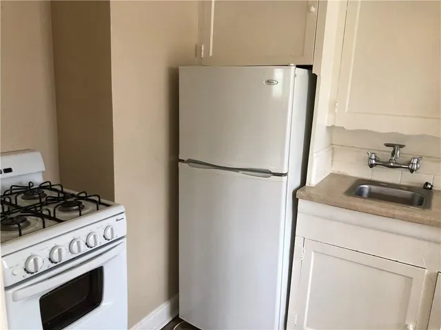 a kitchen with a refrigerator stove and microwave