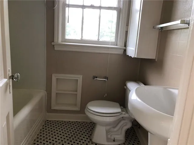 a bathroom with a toilet a sink and a bathtub