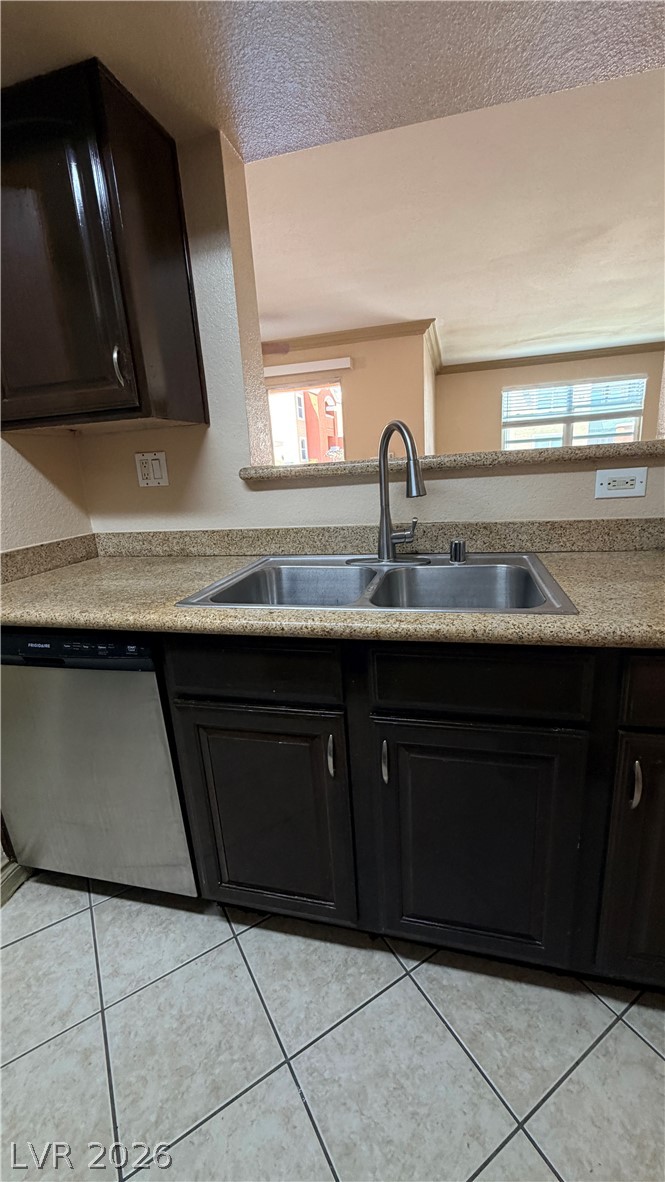 8101 West Flamingo Road, Unit 1082 Las Vegas, NV 89147 - Photo 17 of 23 Functional kitchen with ample cabinet space and a convenient pass-through window to the living area.