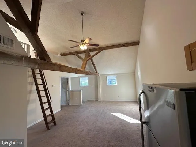 a view of a livingroom with furniture and staircase