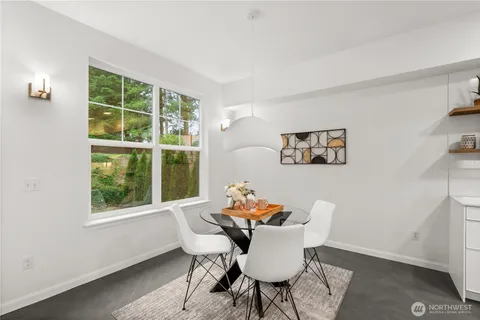 a dining room with furniture and window