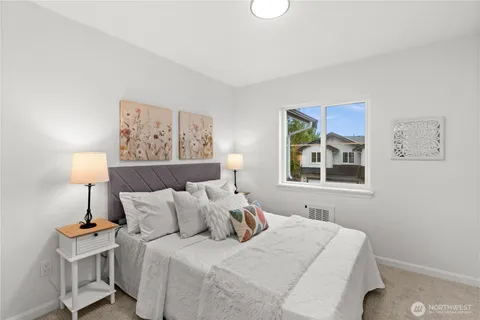 a bedroom with a bed and a lamp