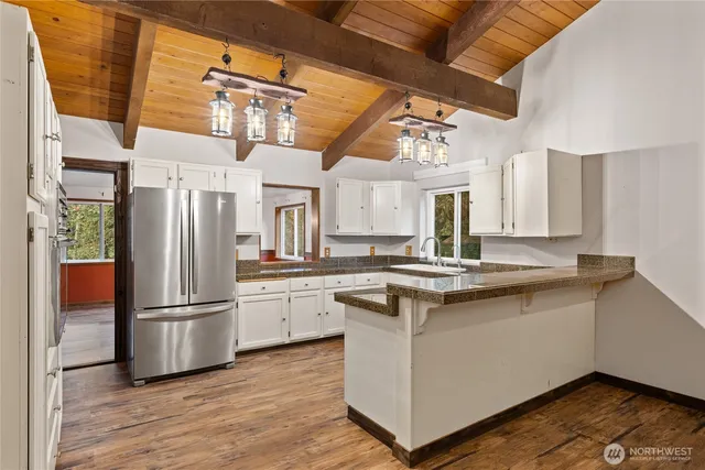 a view of an empty room with a fireplace and a window