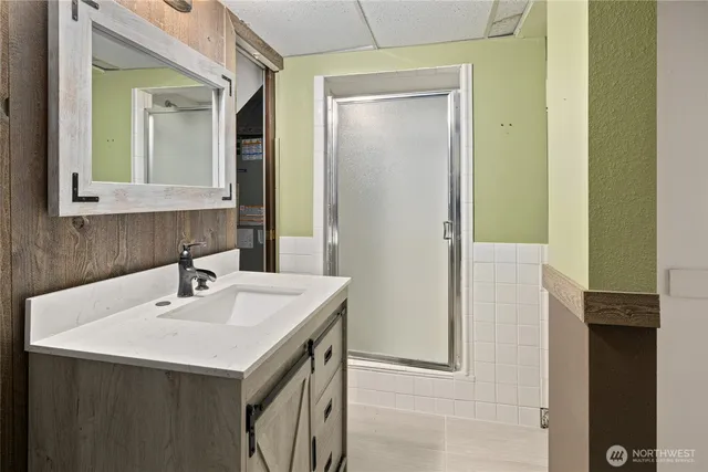 a bathroom with a granite countertop sink and a mirror