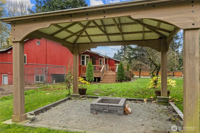 a kitchen with granite countertop a sink stainless steel appliances and white cabinets