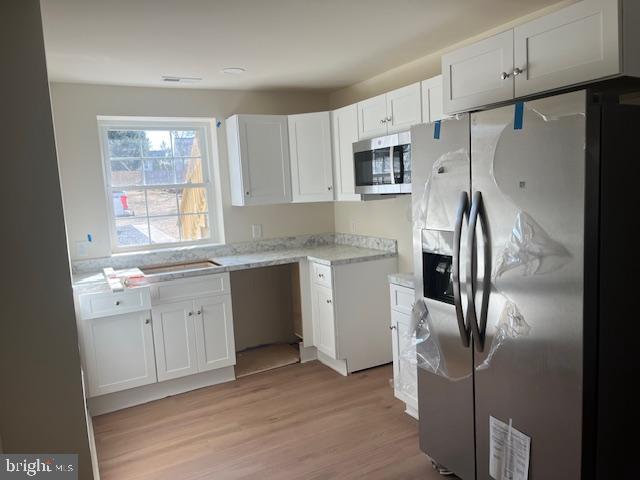 2210 New Falls Road, Unit A Bristol, PA 19007 - Photo 2 of 9 a kitchen with stainless steel appliances a refrigerator sink and microwave