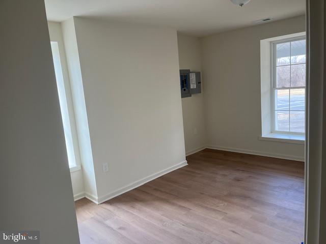 2210 New Falls Road, Unit A Bristol, PA 19007 - Photo 4 of 9 an empty room with wooden floor and windows