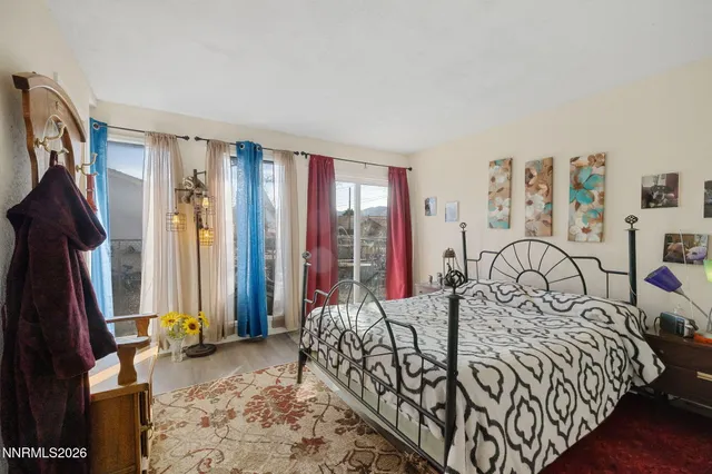 a bedroom with a bed and a large mirror