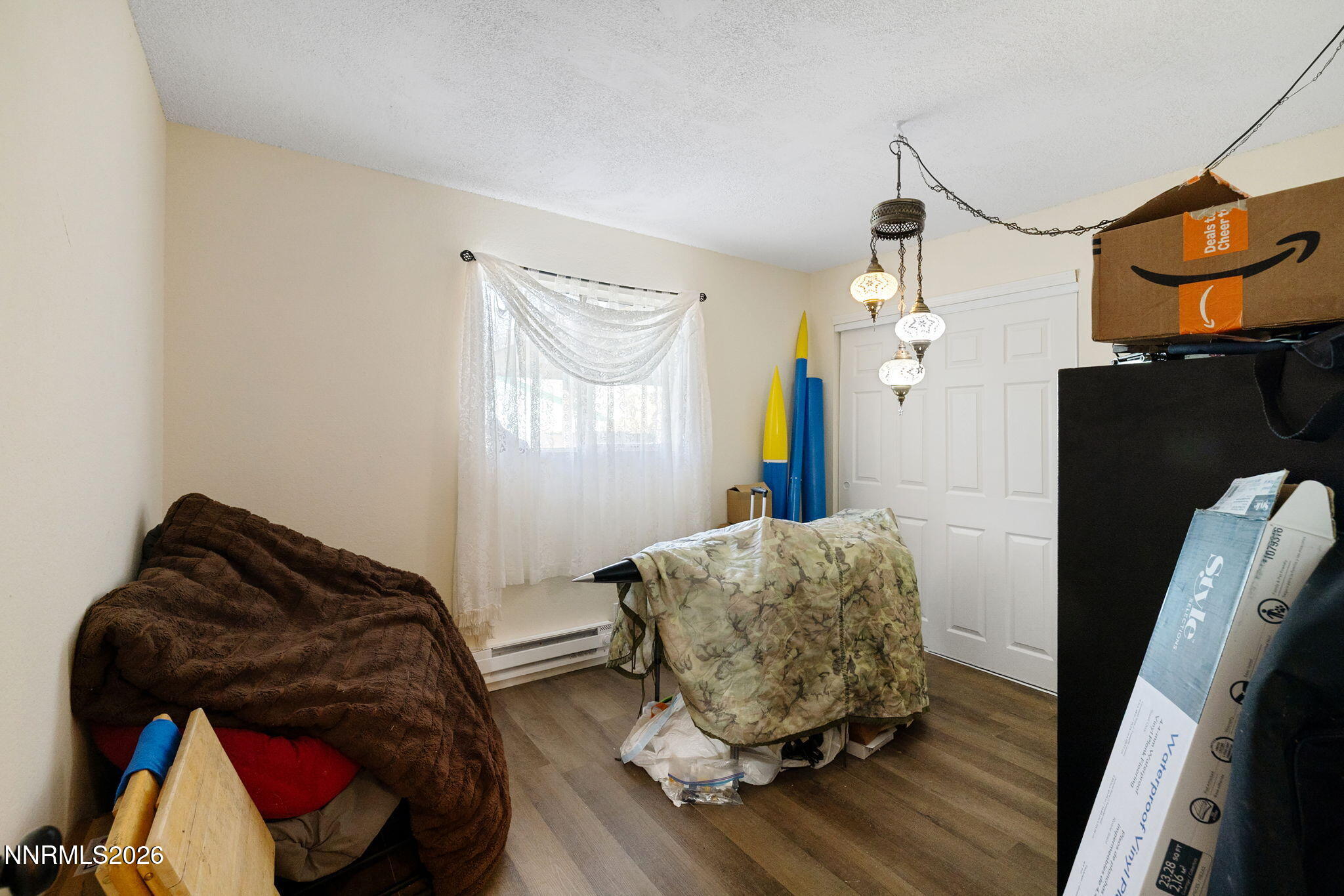 145 K Street Hawthorne, NV 89415 - Photo 17 of 25 a bedroom with a bed and wooden floor