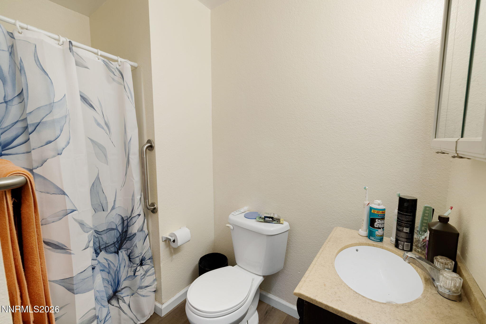 145 K Street Hawthorne, NV 89415 - Photo 20 of 25 a white toilet sitting next to a bathroom sink and a mirror