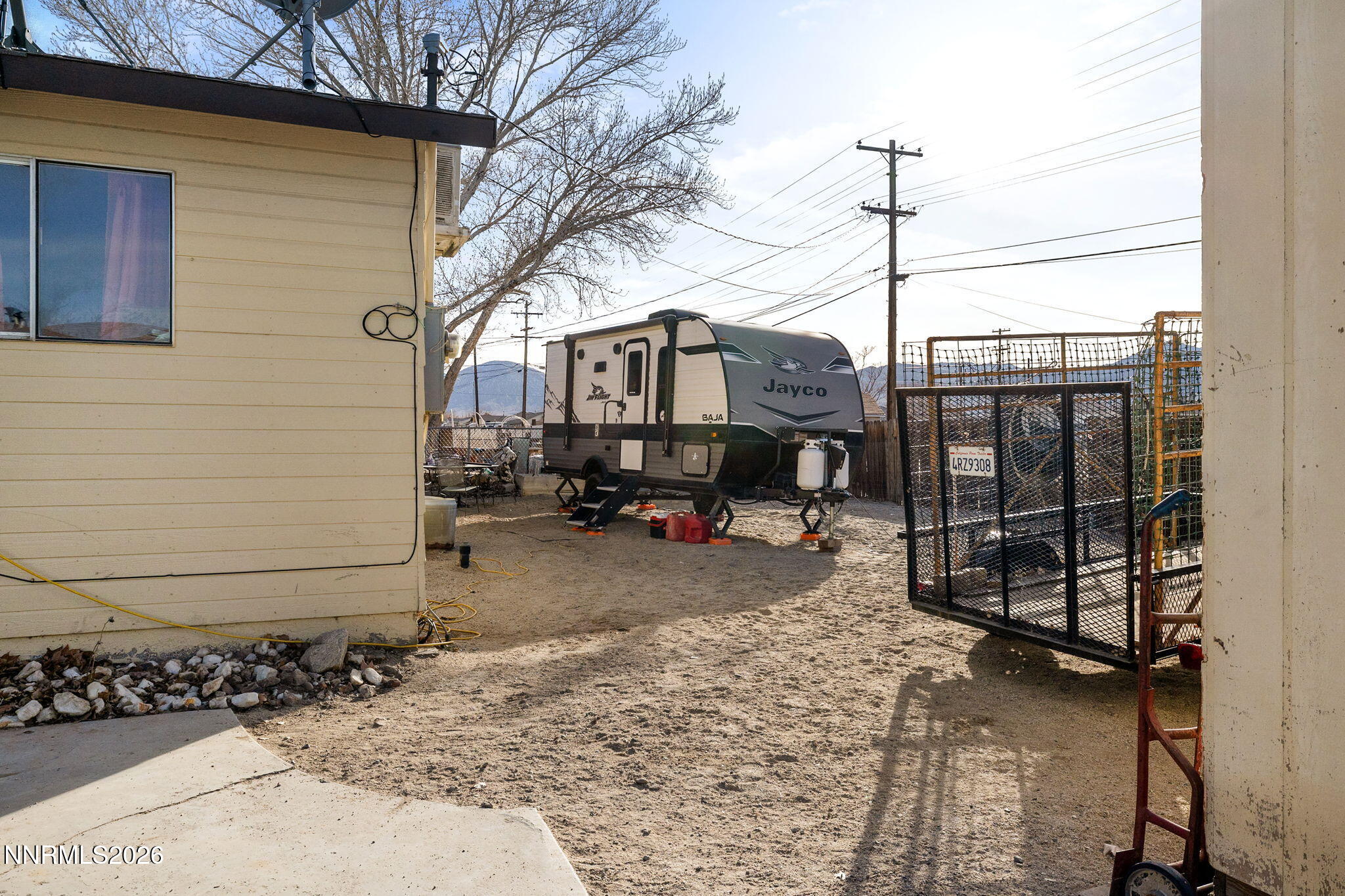 145 K Street Hawthorne, NV 89415 - Photo 21 of 25 a backyard of a house with barbeque oven table and chairs