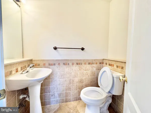 a bathroom with a sink mirror and toilet