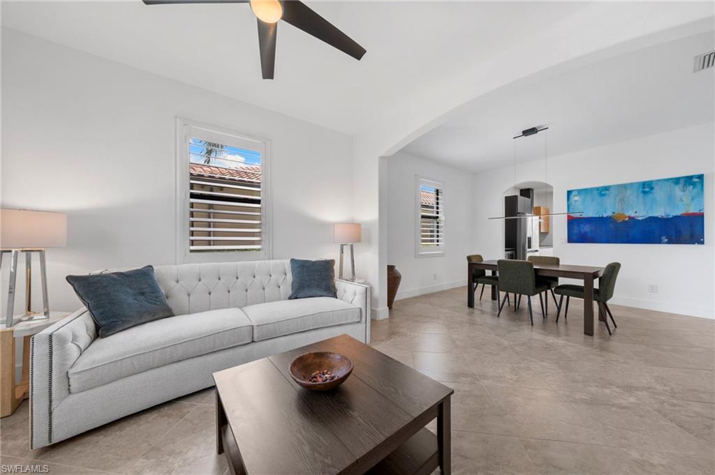 4764 Formosa Drive Naples, FL 34119 - Photo 11 of 32 a living room with furniture and a large window