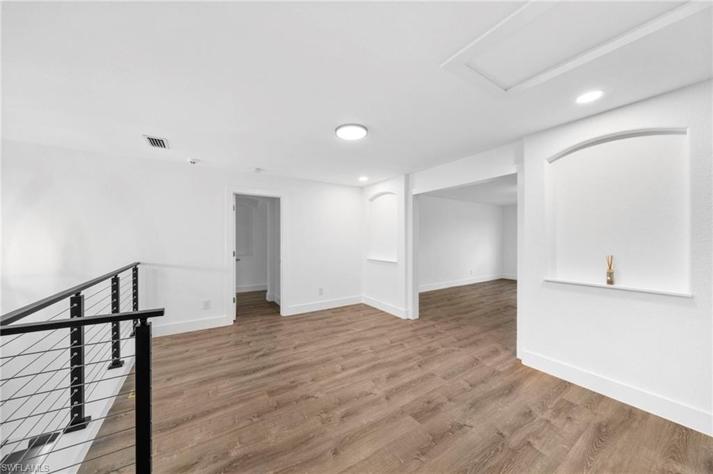 4764 Formosa Drive Naples, FL 34119 - Photo 14 of 32 a view of an empty room with wooden floor