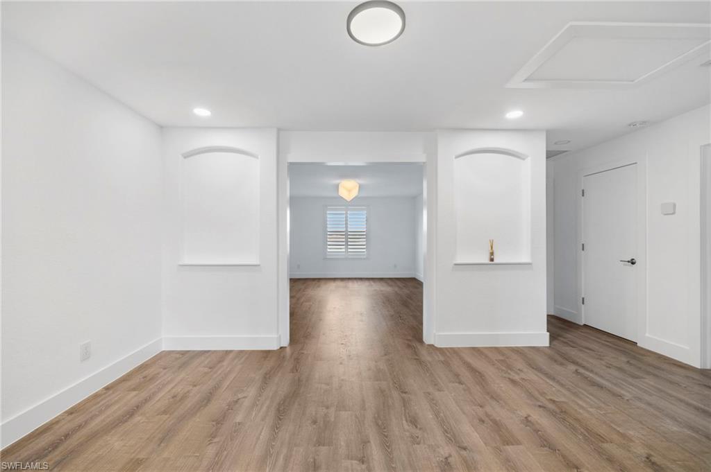 4764 Formosa Drive Naples, FL 34119 - Photo 15 of 32 a view of livingroom with hardwood floor and hallway