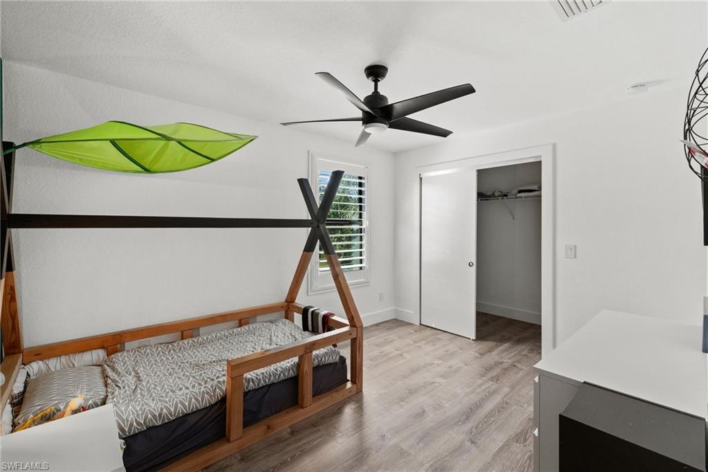 4764 Formosa Drive Naples, FL 34119 - Photo 19 of 32 a living room with a bed furniture and a window
