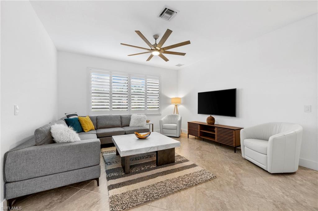 4764 Formosa Drive Naples, FL 34119 - Photo 6 of 32 a living room with furniture and a flat screen tv