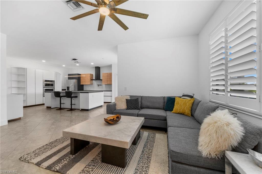 4764 Formosa Drive Naples, FL 34119 - Photo 7 of 32 a living room with furniture and kitchen view