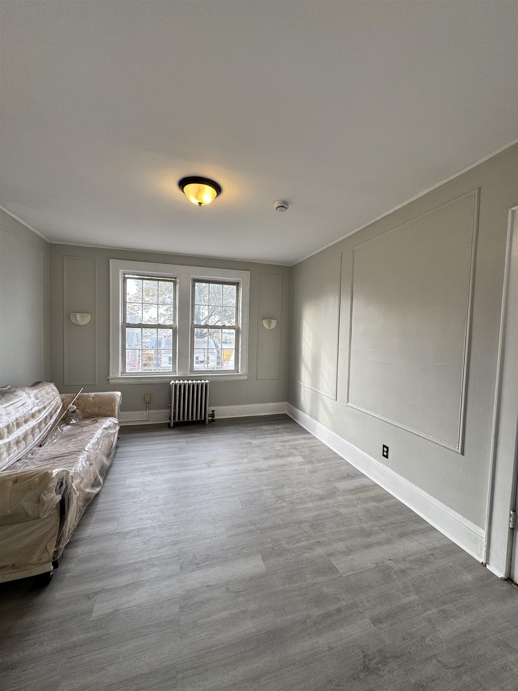 11 Westervelt Place, Unit 2 Irvington, NJ 07111 - Photo 4 of 6 a view of a livingroom with furniture and windows