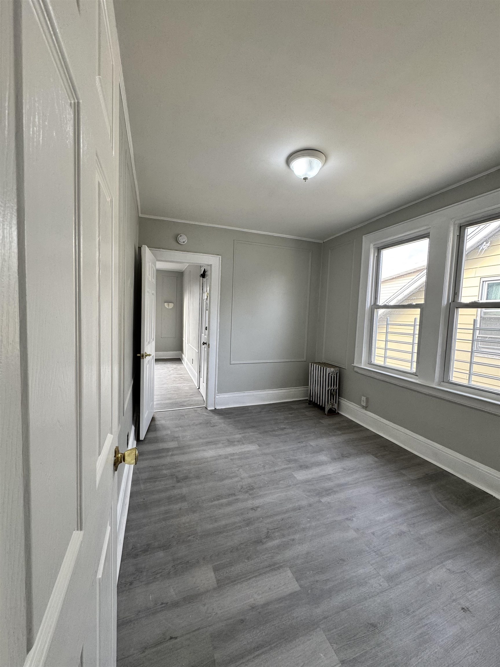 11 Westervelt Place, Unit 2 Irvington, NJ 07111 - Photo 5 of 6 wooden floor and windows in a room