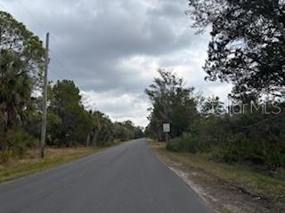 6185 South Hancock Road Homosassa, FL 34448 - Photo 2 of 9 a view of a road with a trees in the background