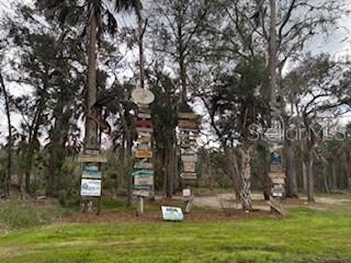 6185 South Hancock Road Homosassa, FL 34448 - Photo 3 of 9 a backyard of a house with lots of green space and fountain