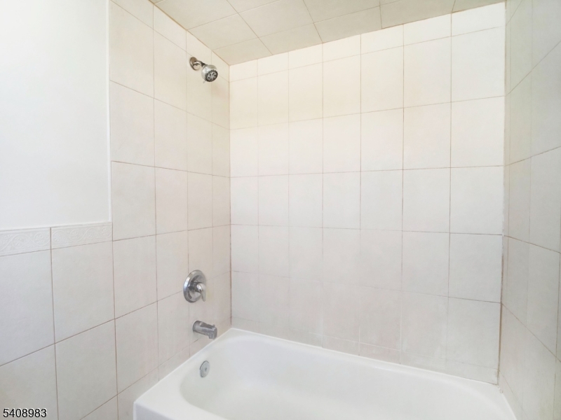 91 William Street East Orange, NJ 07017 - Photo 8 of 10 a bathroom with a bathtub