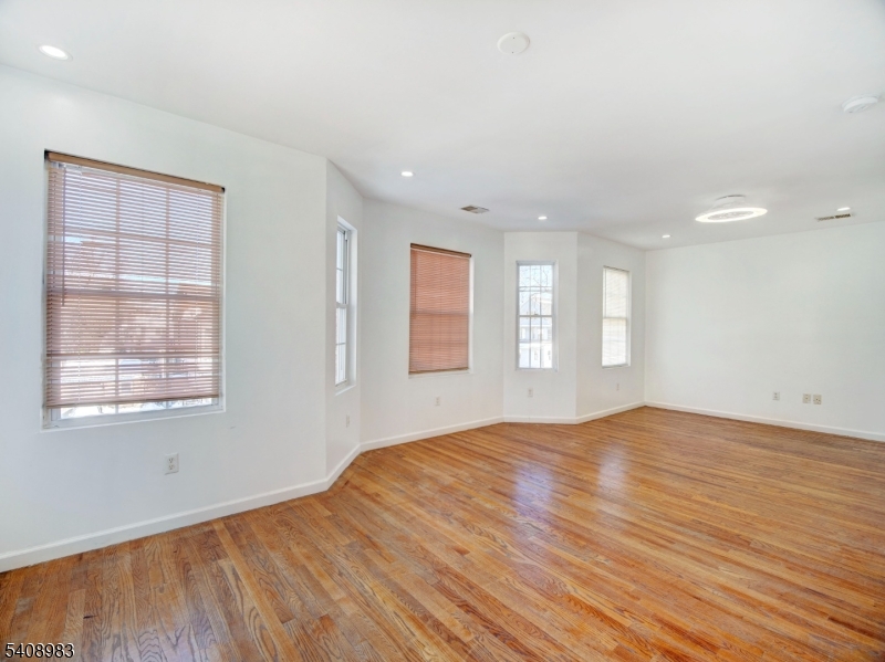 91 William Street East Orange, NJ 07017 - Photo 9 of 10 an empty room with wooden floor and windows