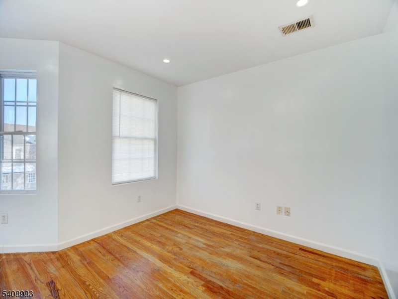 91 William Street East Orange, NJ 07017 - Photo 10 of 10 a view of empty room with wooden floor and fan