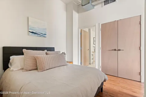a bedroom with a large bed and a chandelier