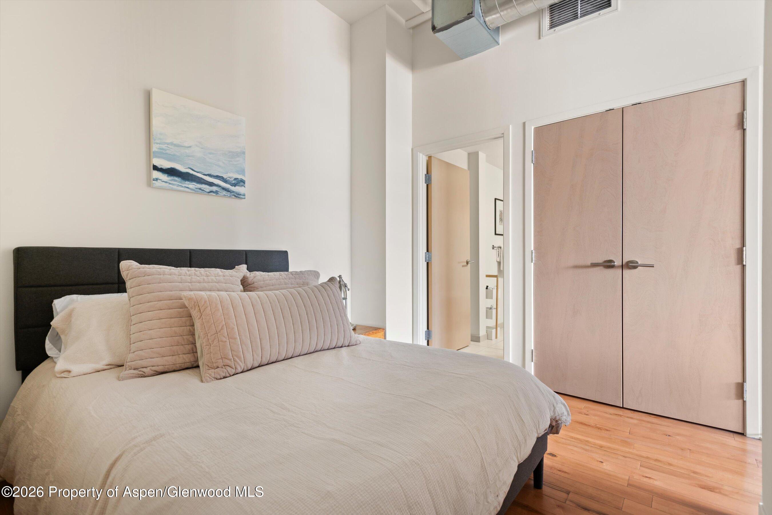 361 Robinson Street, Unit 240 Basalt, CO 81621 - Photo 6 of 11 a bedroom with a large bed and a chandelier