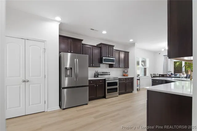 a kitchen with a refrigerator a stove top oven a sink and dishwasher