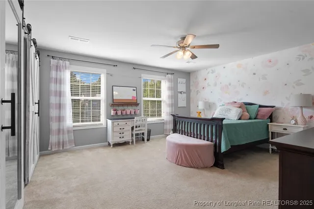 a spacious bedroom with a bed and a chandelier