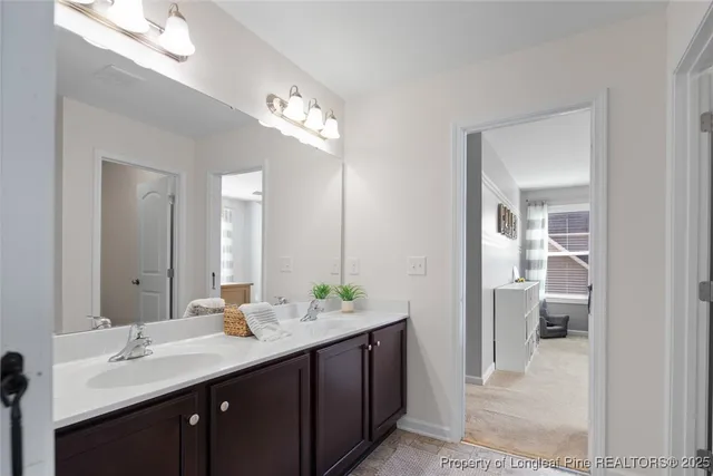 a bathroom with a double vanity sink and a mirror