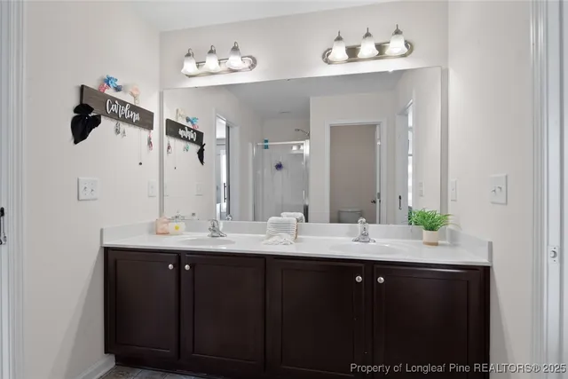 a bathroom with a double vanity sink and a mirror