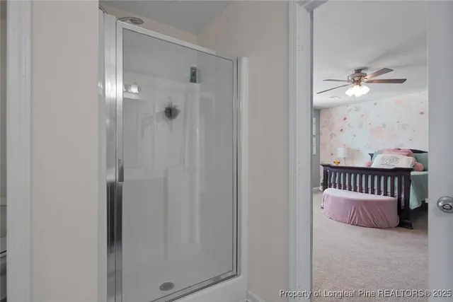 a view of a hallway with closet and chandelier