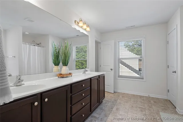 a bathroom with a sink double vanity and a mirror