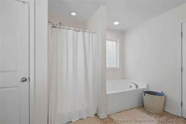 a bathroom with a bathtub and shower