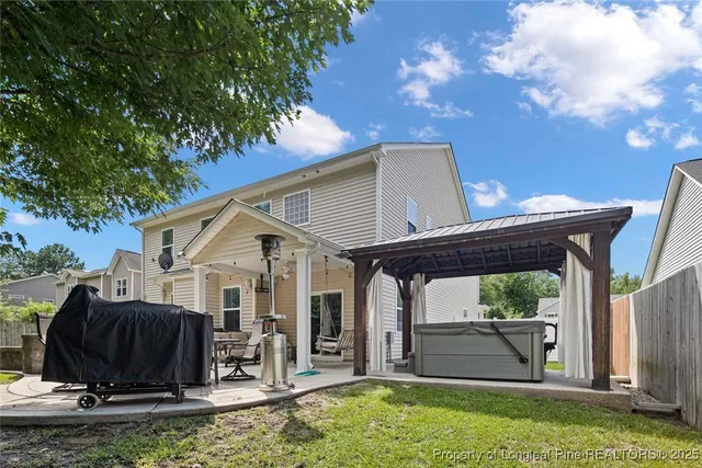a view of a house with backyard porch and sitting area