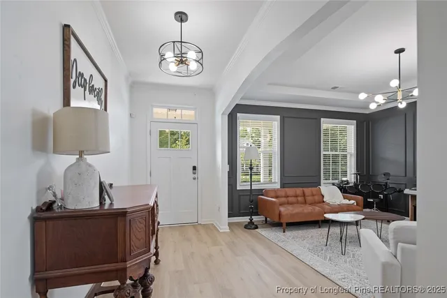 a living room with furniture a window and a chandelier