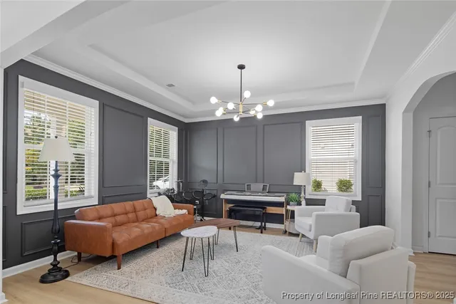 a living room with furniture and a chandelier