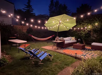 a view of a house with backyard tub and sitting area