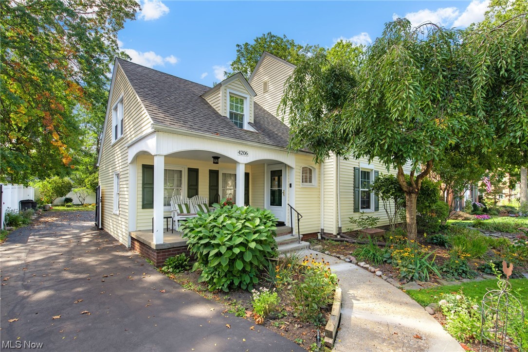 New england style home with a porch