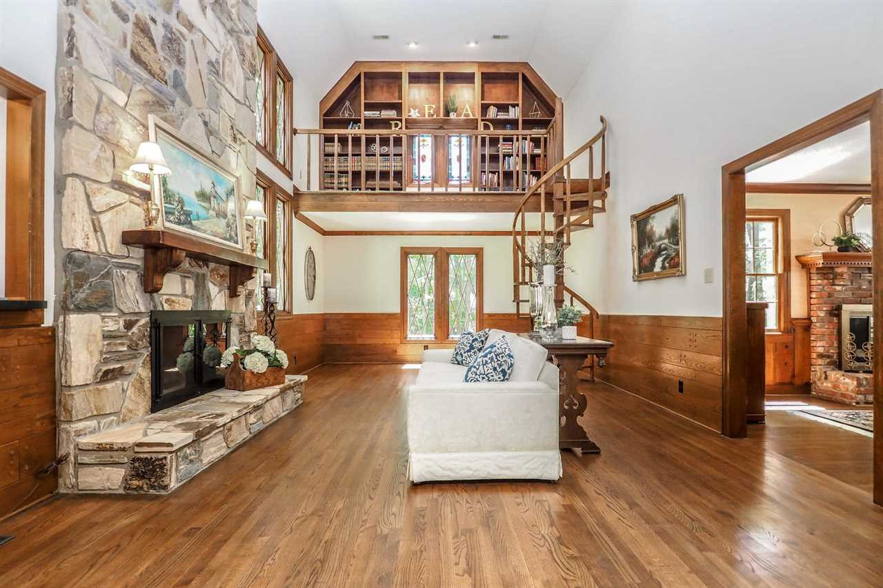 5009 Field And Stream Road Raleigh, NC 27613 - Photo 3 of 12 LIVING room with a unique SPIRAL staircase leading to a reading NOOK. Living Room