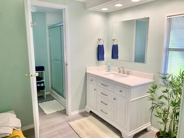 a bathroom with a sink a vanity and a mirror