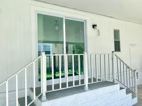 a view of an empty room with a floor to ceiling window and stairs