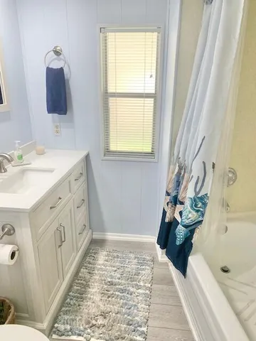 a bathroom with a tub sink and mirror
