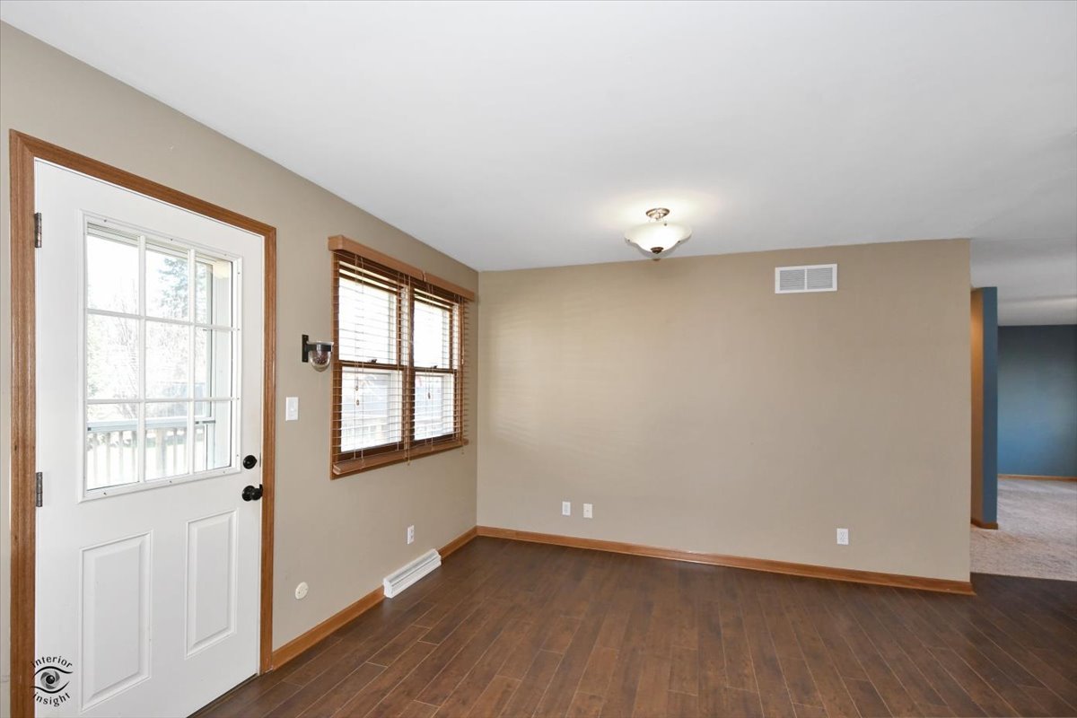 616 Northgate Road New Lenox, IL 60451 - Photo 14 of 34 a view of an empty room with wooden floor and a window